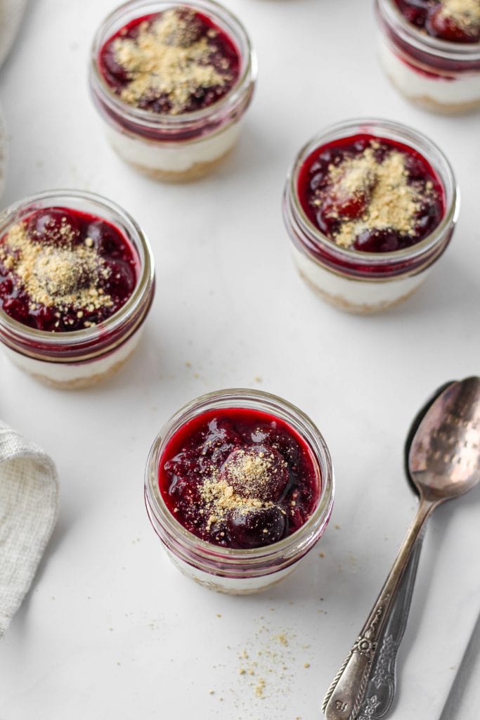 This no-bake cheesecake in a jar is simple + quick to make and it's served in mini mason jars...cute, right? Complete with graham cracker "crust", cheesecake filling, and cherry cheesecake topping!