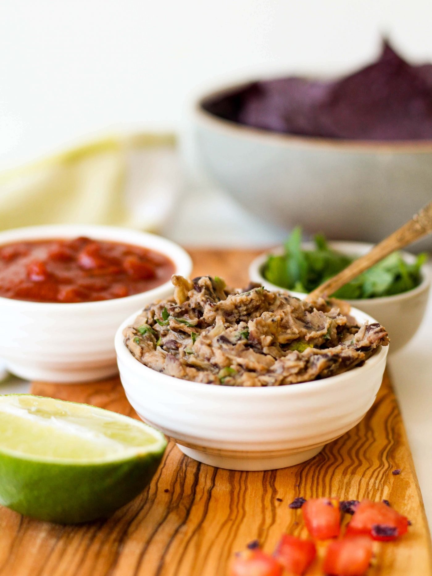 This super easy, healthy refried black beans recipe is the key to all of your quick weeknight meals! Just spread it onto a tortilla, taco shell, or salad with veggies and you've got a protein-packed, plant-based meal!