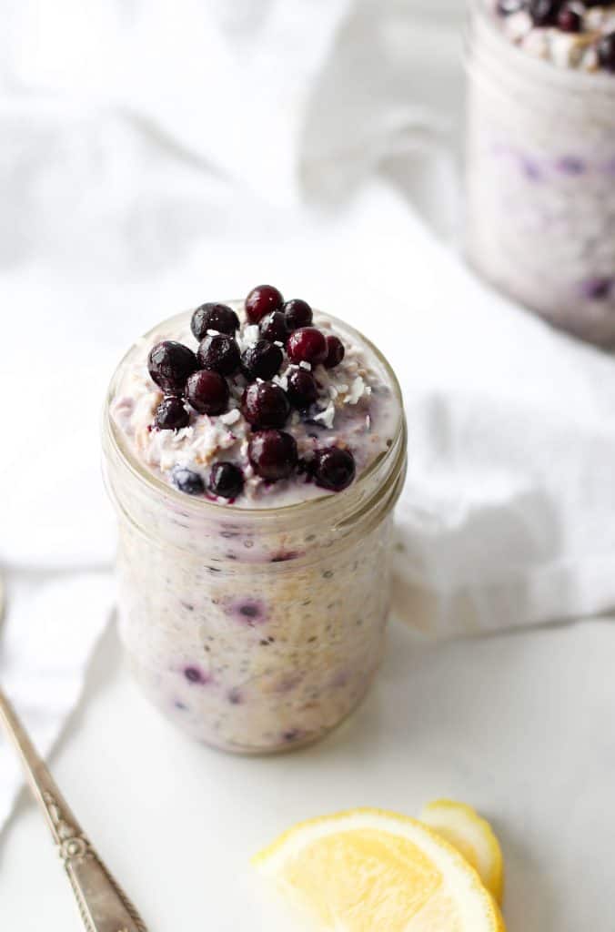 overnight oats topped with blueberries in a mason jar