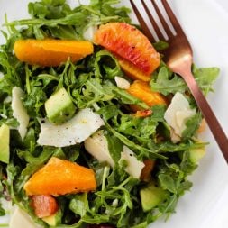 This healthy, easy Citrus Arugula salad makes a delicious lunch or side dish to pair with whatever you're cooking for dinner. The sweet citrus pairs so well with the crisp arugula, sharp parmesan cheese and buttery avocado. The dressing is a light Lemon Honey Vinaigrette.