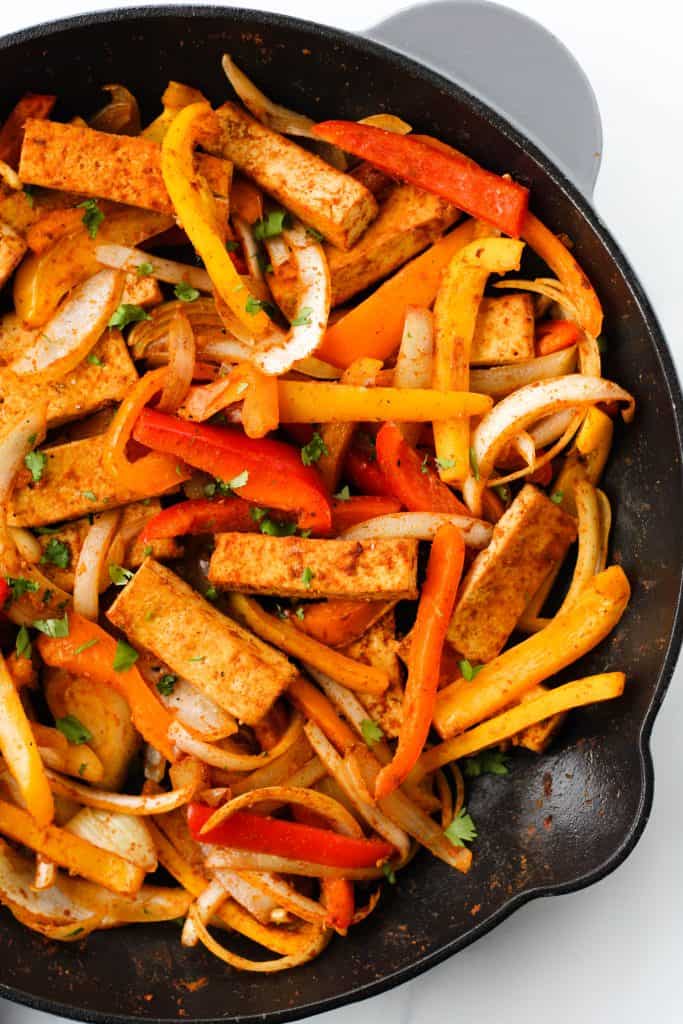 Add these Easy Tofu Fajitas to your list of quick and healthy meals to try! This plant-based recipe takes 30 minutes to make and is packed with protein and nutritious vegetables.