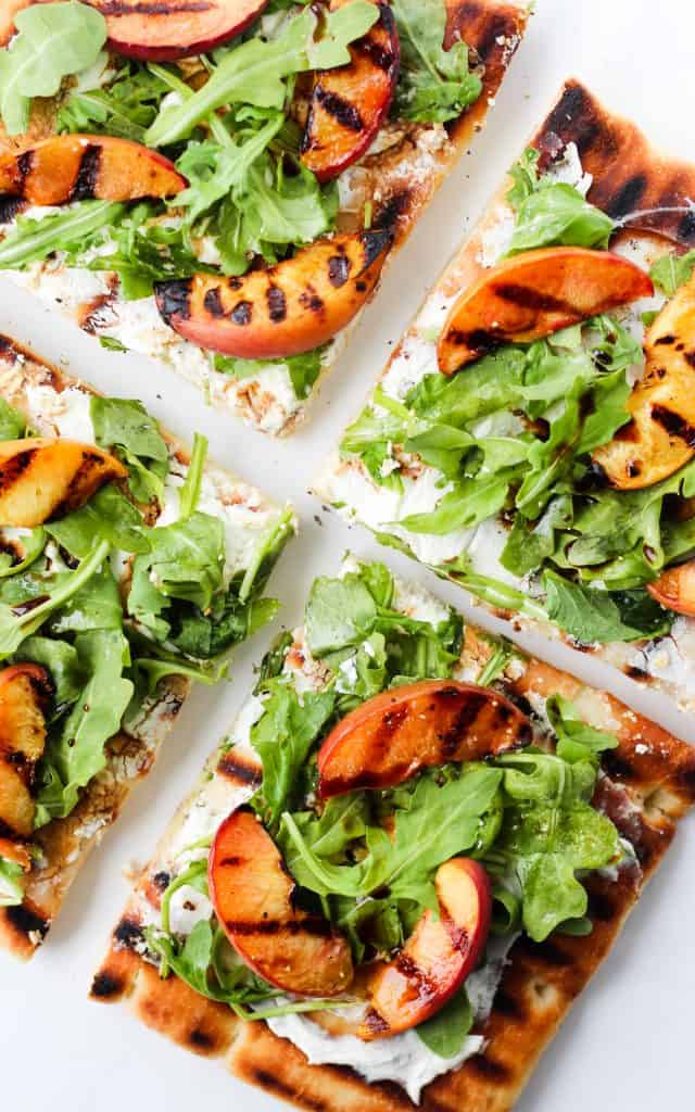 This grilled peach and arugula flatbread pizza with goat cheese and balsamic is an easy and delicious summer meal.