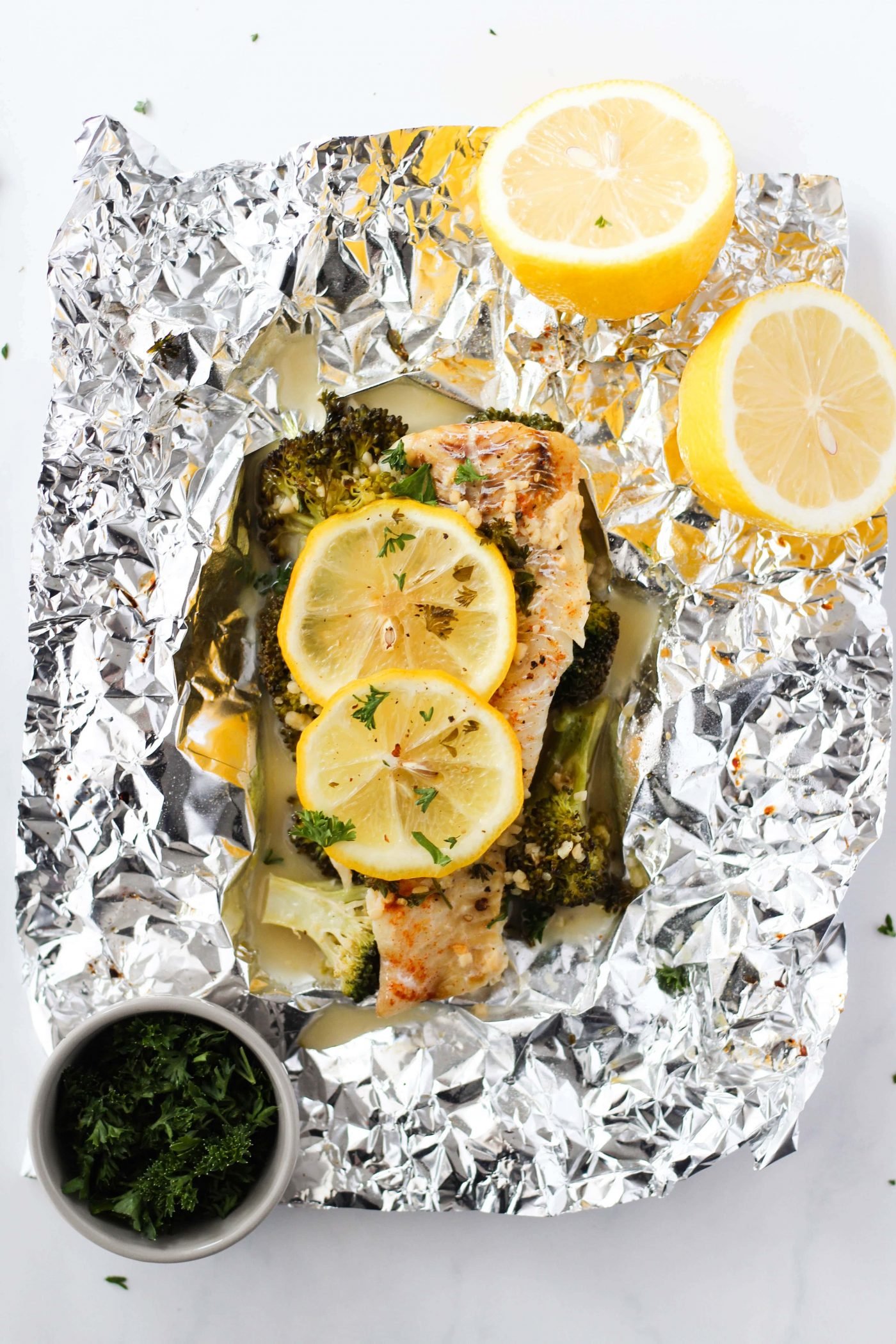 Baked haddock in foil with broccoli