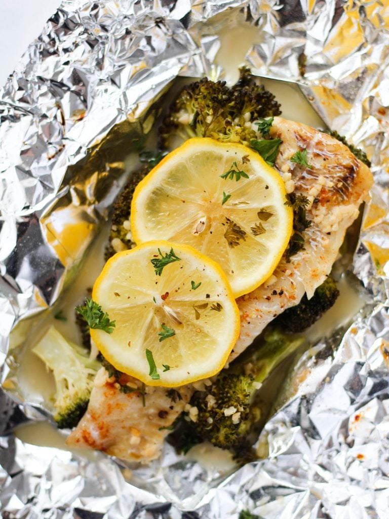 Baked lemon butter haddock in foil with broccoli and lemon