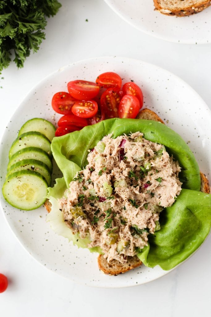 This healthy tuna salad makes a filling, easy lunch or snack. Instead of mayonnaise, we're using hummus and adding celery and red onion. You can serve it on its own, on crackers, sandwiches or toast. It's a delicious dairy and egg-free tuna salad.