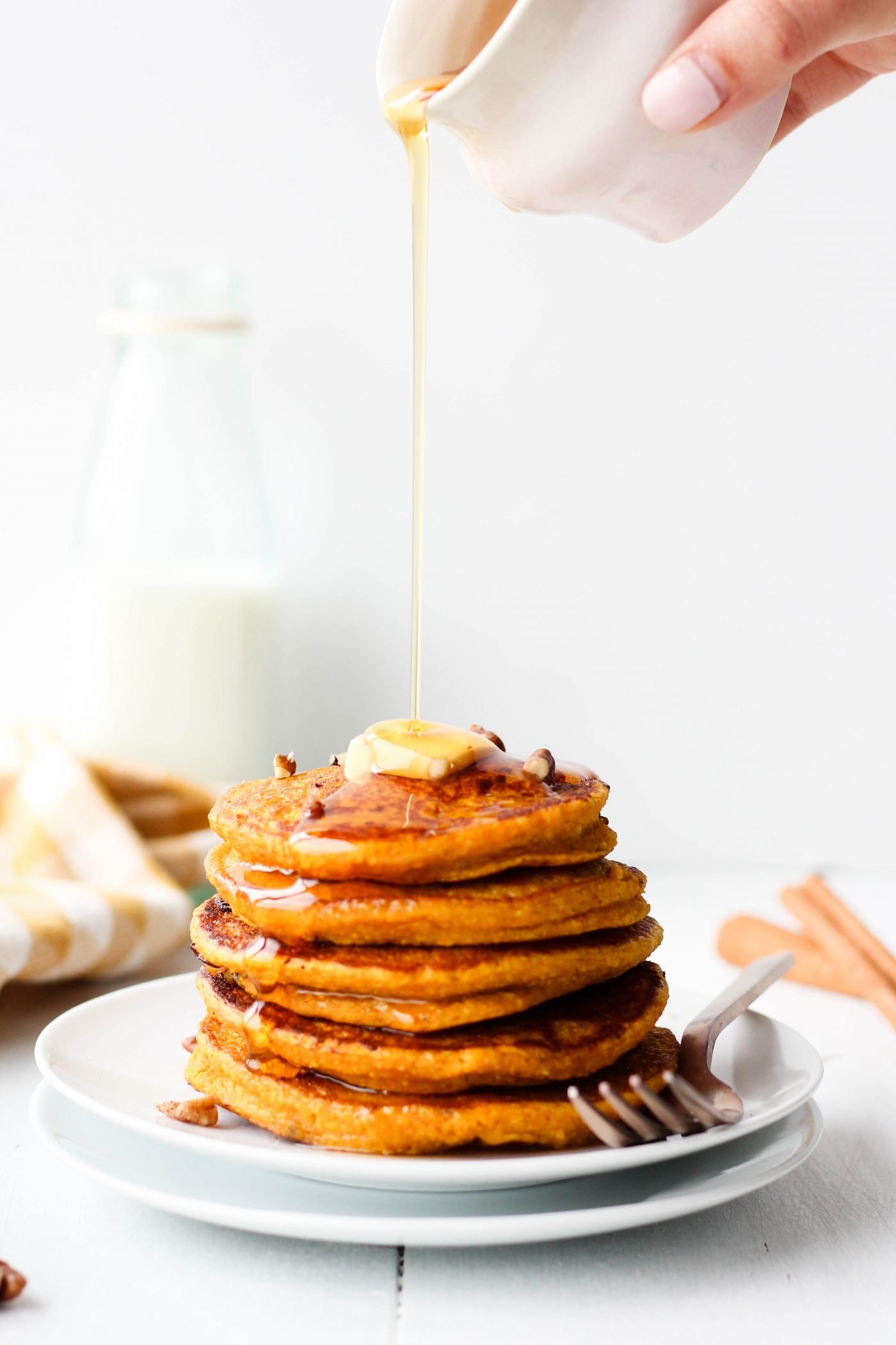 Breakfast just got so much easier with these Oatmeal Pumpkin Pancakes! Just throw all the ingredients in a blender and cook on a pan for delicious and healthy pumpkin pancakes. Perfect for fall - or any time of year!