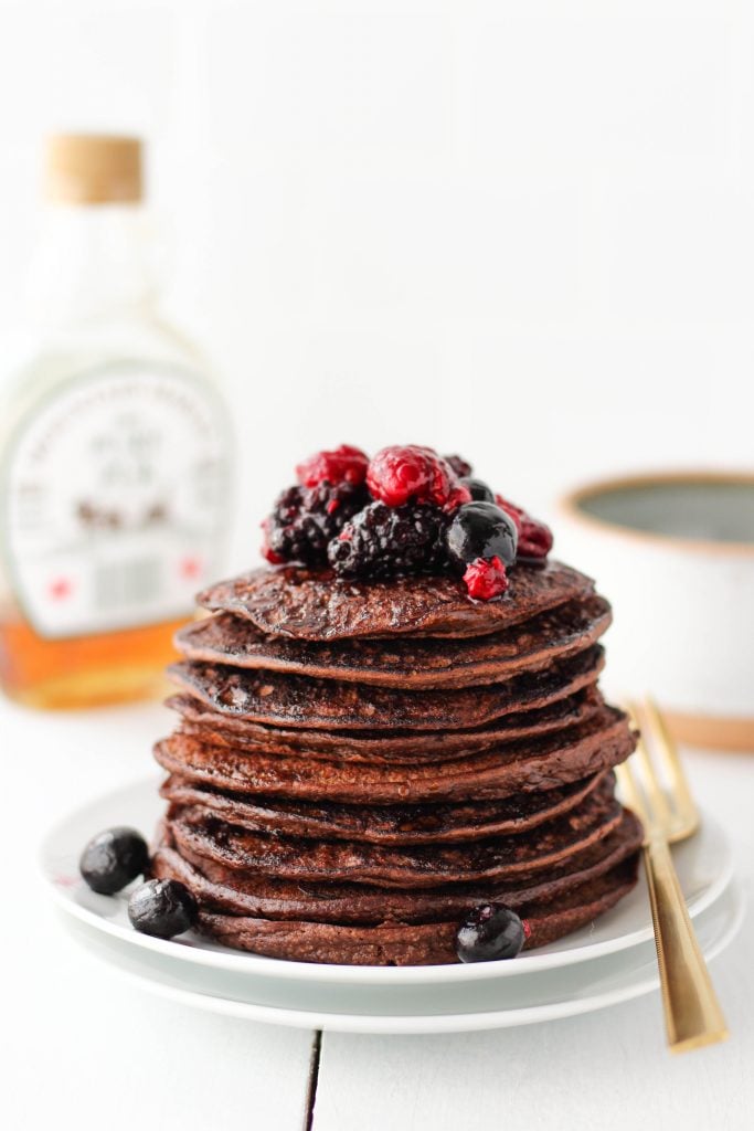 Make these easy Chocolate Protein Pancakes in a flash! Blend ingredients together, cook, then enjoy for a high-protein healthy breakfast. This recipe is perfect for meal-prep. Store leftover pancakes in the fridge or freezer and reheat as needed!