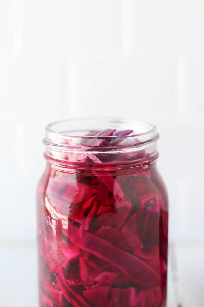 This Quick Pickled Red Cabbage is so easy to make and so tasty! You're going to want to eat it on everything. It's a great addition to salads, tacos, nourish bowls, sandwiches and more.