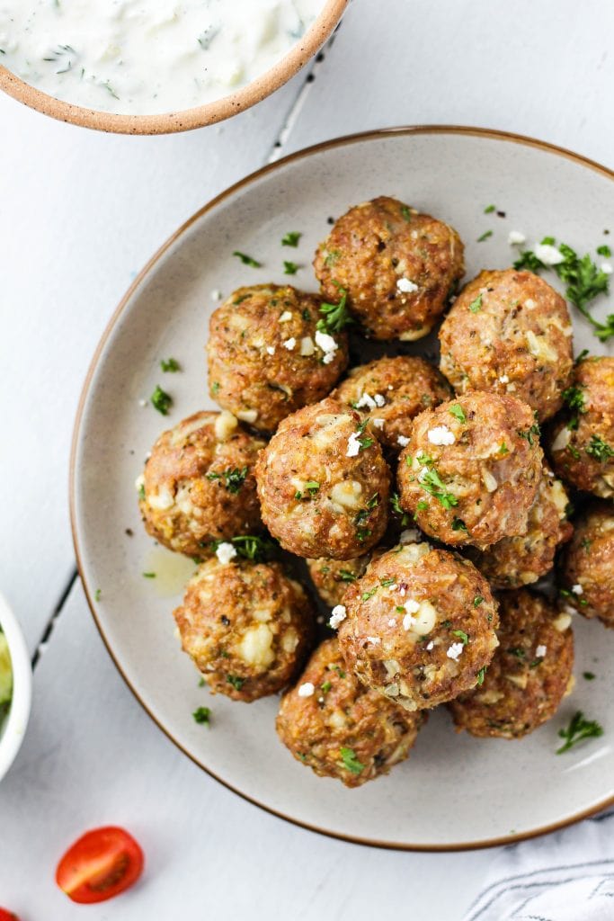 Flavourful and juicy Greek Chicken Meatballs with homemade Tzatziki. They make a delicious lunch or healthy dinner!
