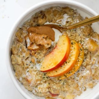 Easy stovetop Peaches and Cream Oatmeal made with rolled oats, fresh peaches, hemp seeds, milk, vanilla, honey, and a splash of half & half.