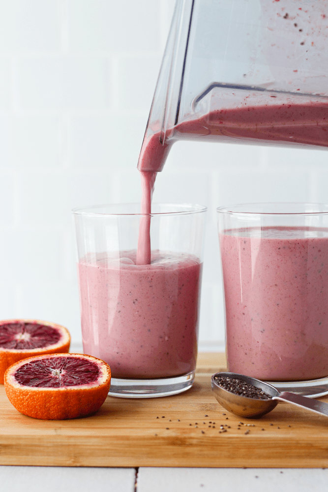 blood orange smoothie being poured into a glass
