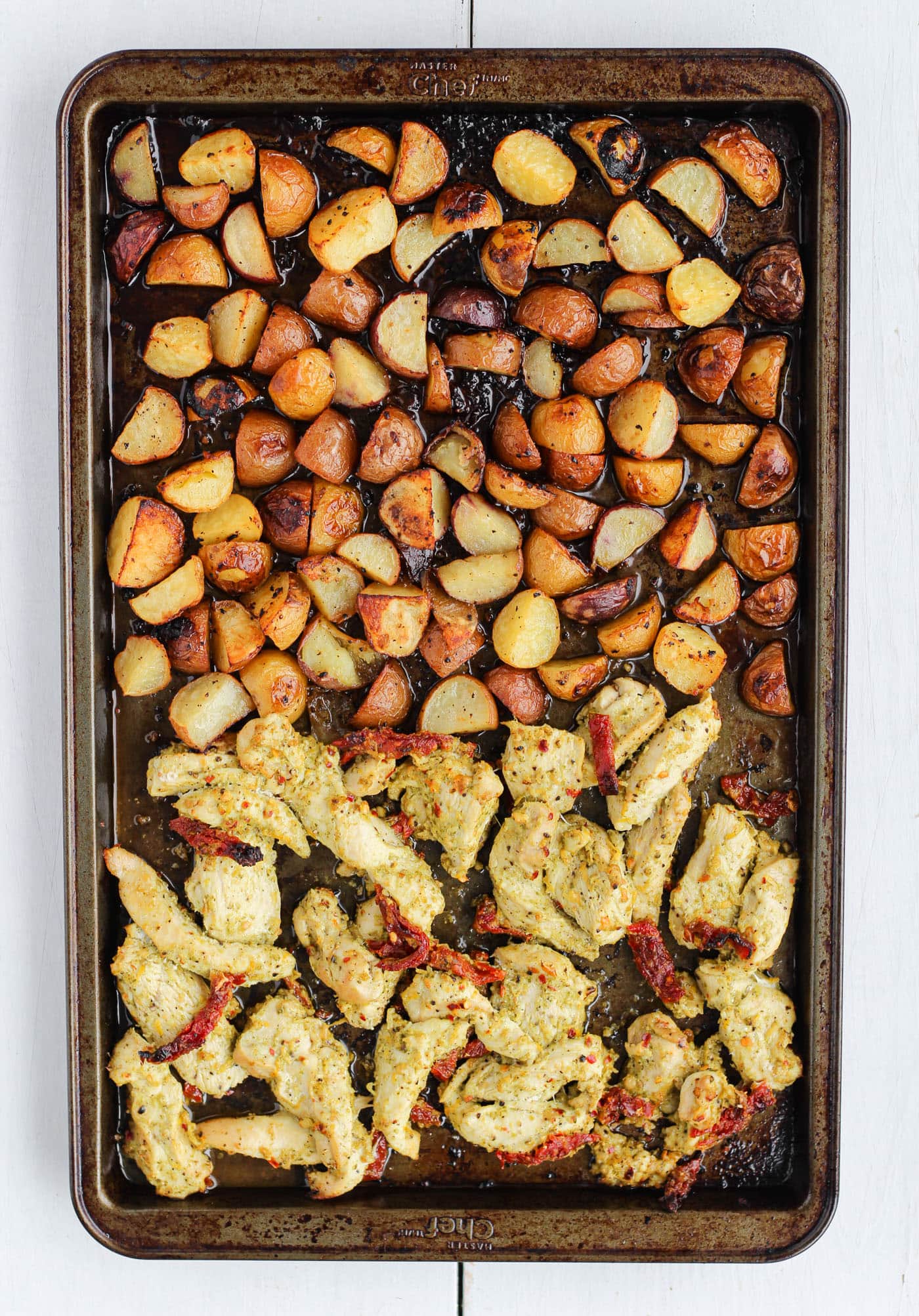 pesto chicken and potatoes in a sheet pan