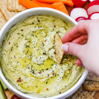 white bean dip with crackers and vegetables