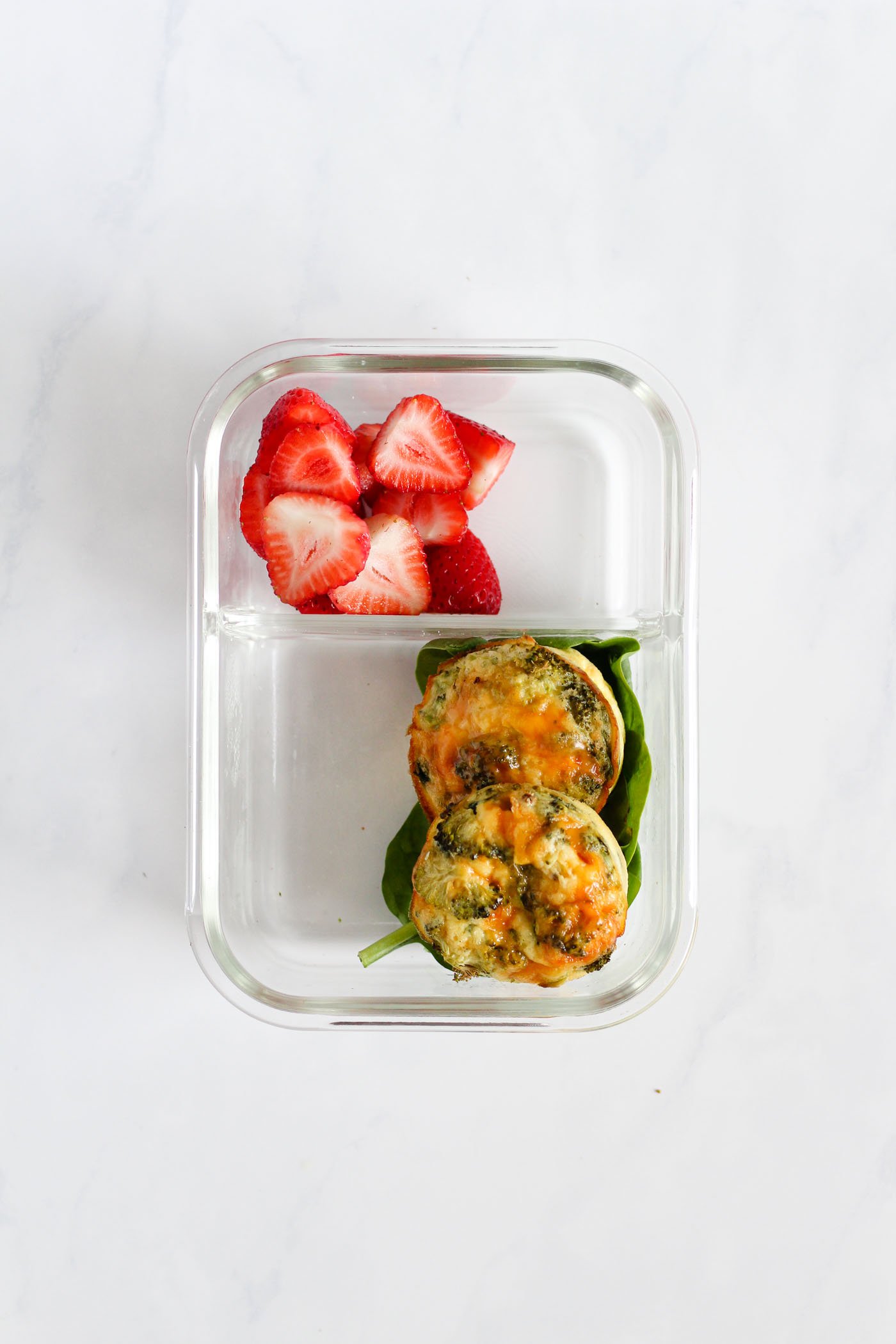lunch box with spinach, strawberries and egg bites