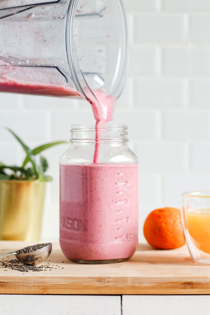 breakfast smoothie being poured into a mason jar