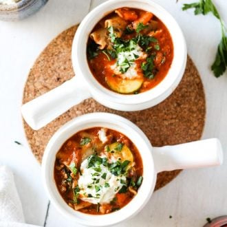 lasagna soup with vegetables in white bowls