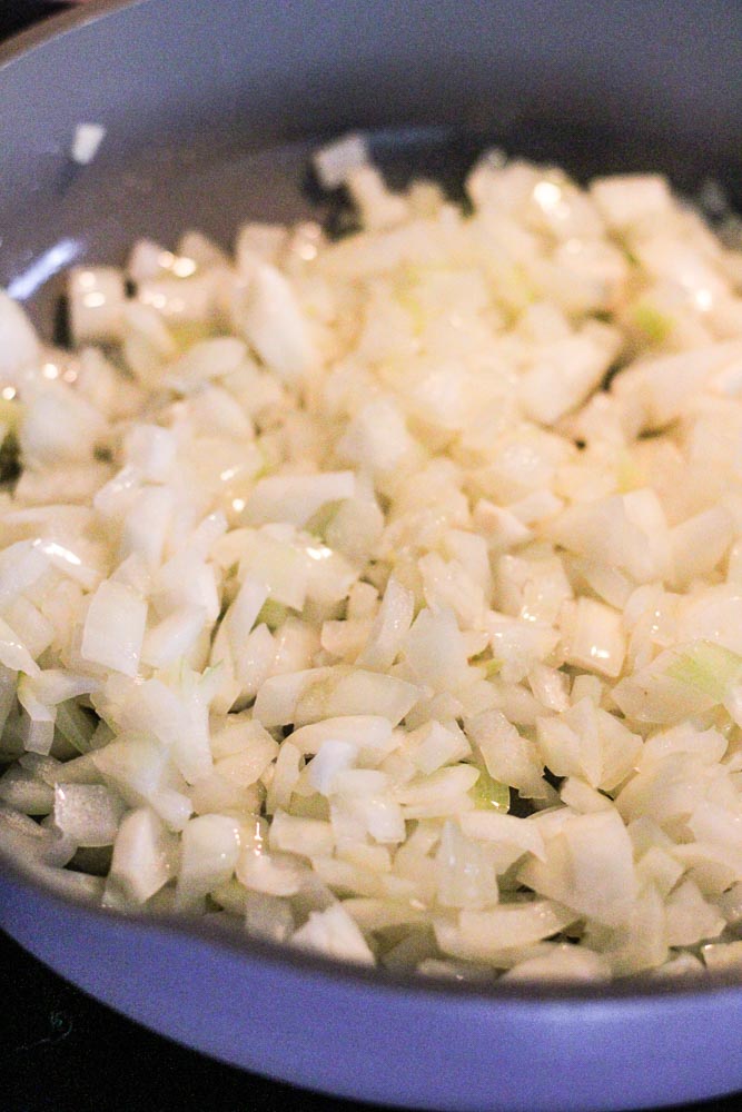 diced onions in a frying pan