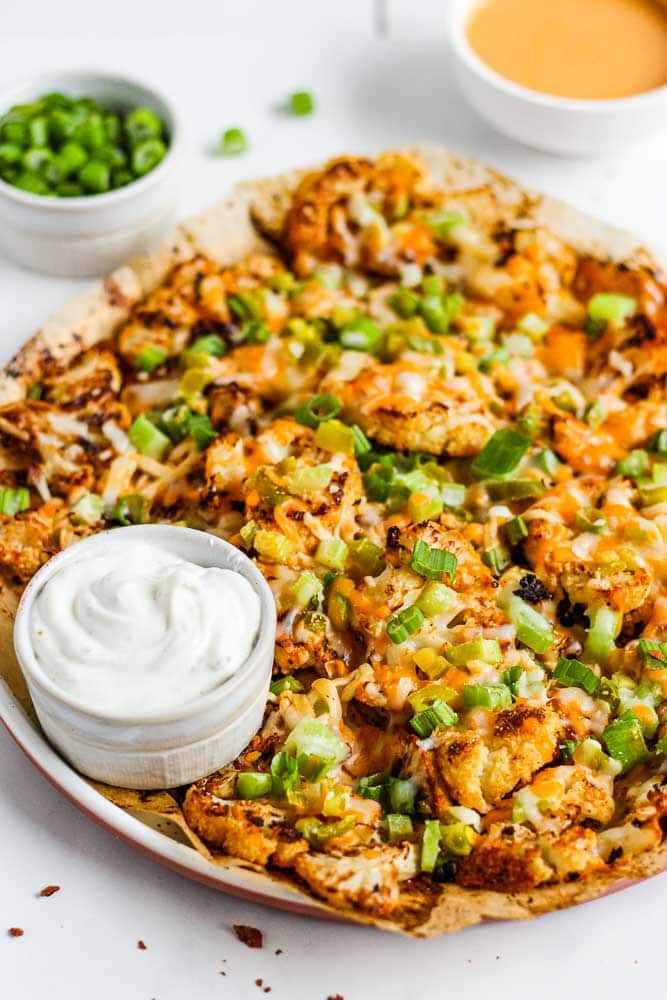 cauliflower nachos on a plate with toppings