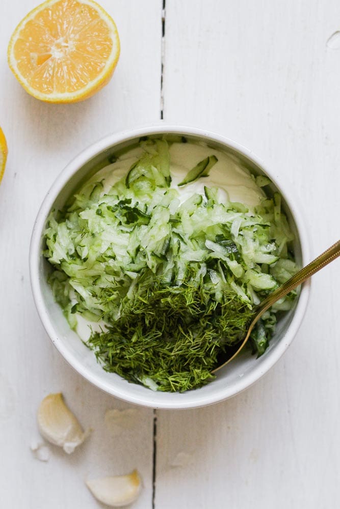 greek yogurt with grated cucumber and fresh dill in a bowl