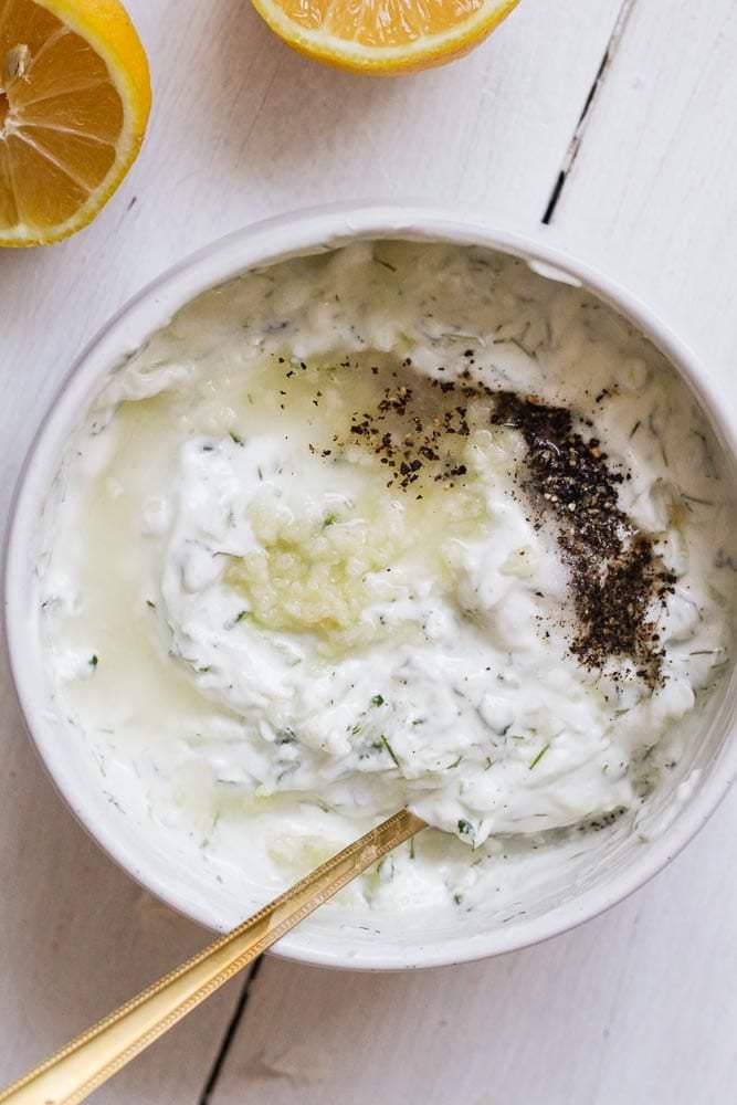 greek yogurt, grated cucumber, fresh dill, lemon juice, salt, pepper, and minced garlic in a bowl