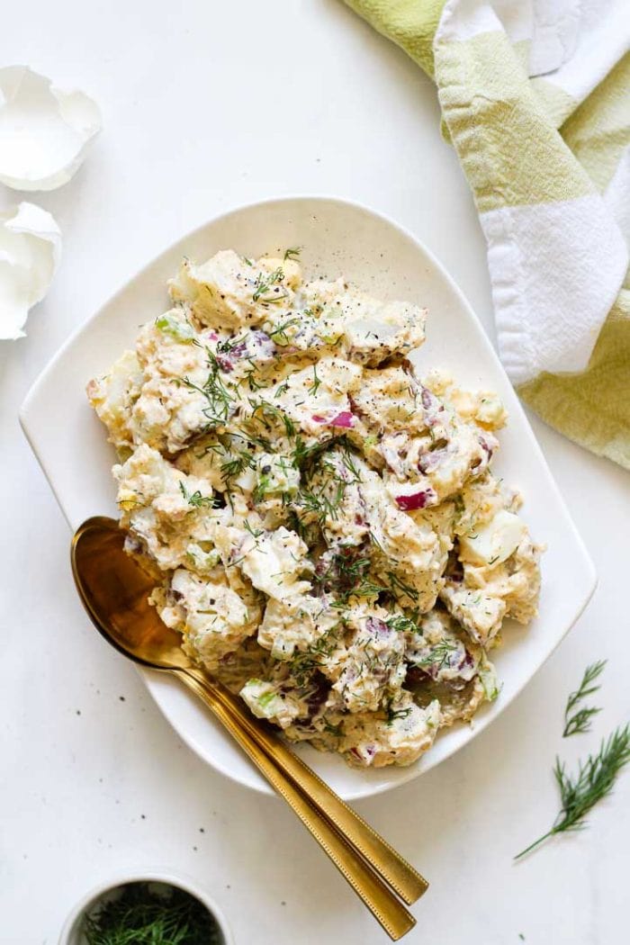 potato salad on a plate with two spoons