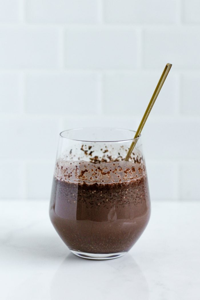 chocolate chia pudding mixture in a glass before refrigerating to set