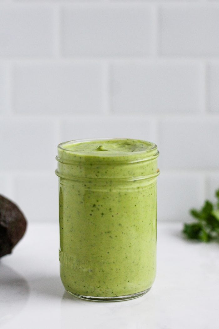 jar of green greek yogurt avocado salad dressing